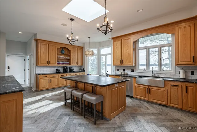 a kitchen with stainless steel appliances granite countertop wooden cabinets a stove top oven a sink and dishwasher