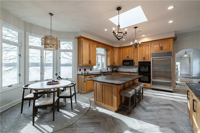 a spacious bedroom with a bed mirror and a window