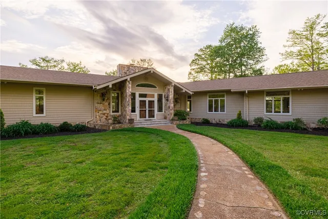a aerial view of a house with swimming pool and sitting area