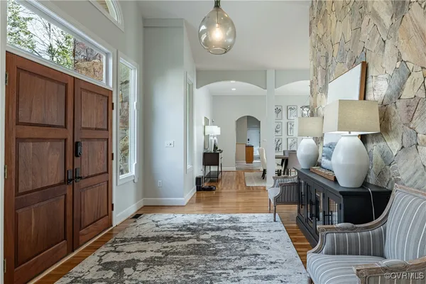 a living room with furniture and wooden floor