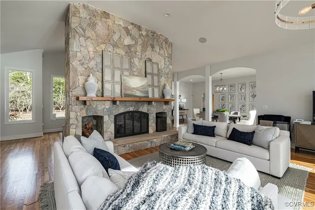 a living room with furniture a chandelier and a flat screen tv