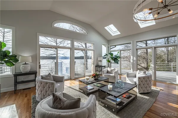 a living room with furniture and a chandelier