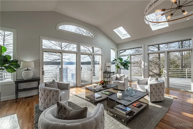 a living room with furniture and a chandelier