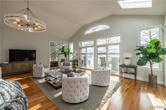 a view of a dining room with furniture wooden floor and chandelier