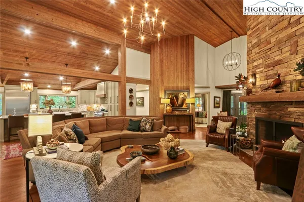 a living room with furniture a fireplace and a table