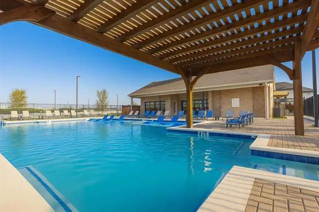 a view of swimming pool with outdoor seating