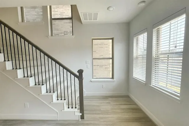 a view of an entryway with wooden floor