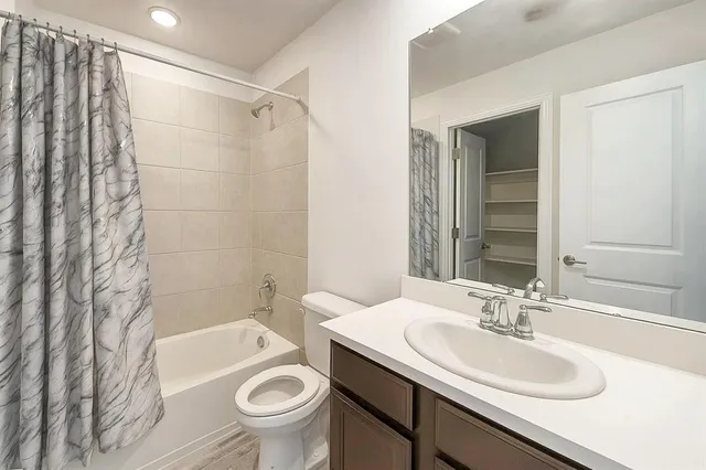 a bathroom with a sink toilet and a mirror