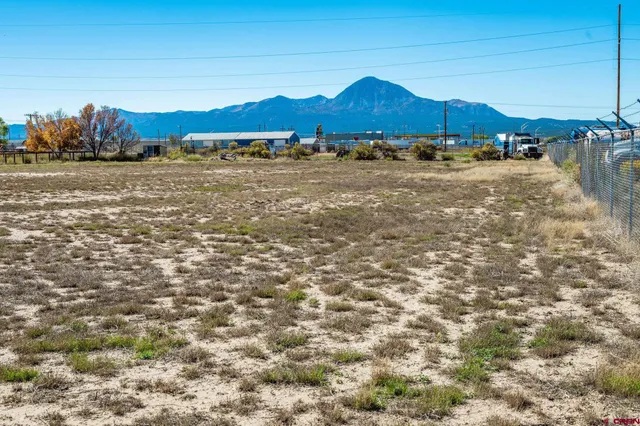 a view of dirt and mountain view in back yard