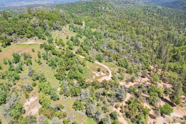 an aerial view of a house with a yard