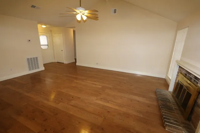 wooden floor in an empty room with a fireplace