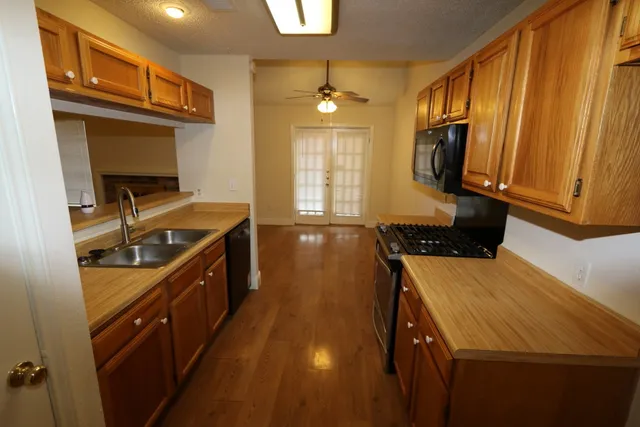 a kitchen with a sink and wooden cabinets