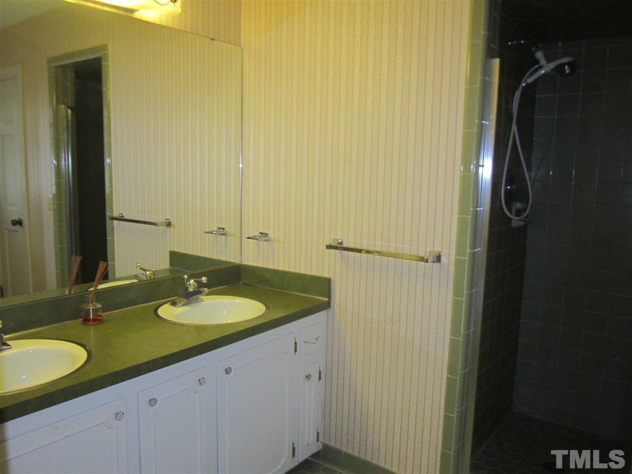 1401 Falls Church Road Raleigh, NC 27609 - Photo 11 of 11 a bathroom with a granite countertop sink and a mirror