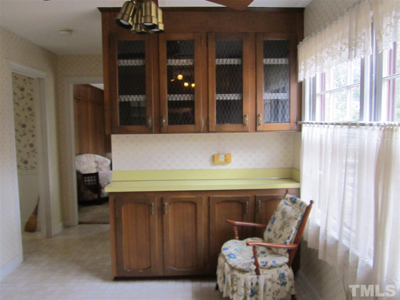 1401 Falls Church Road Raleigh, NC 27609 - Photo 3 of 11 a room with a chair and potted plant