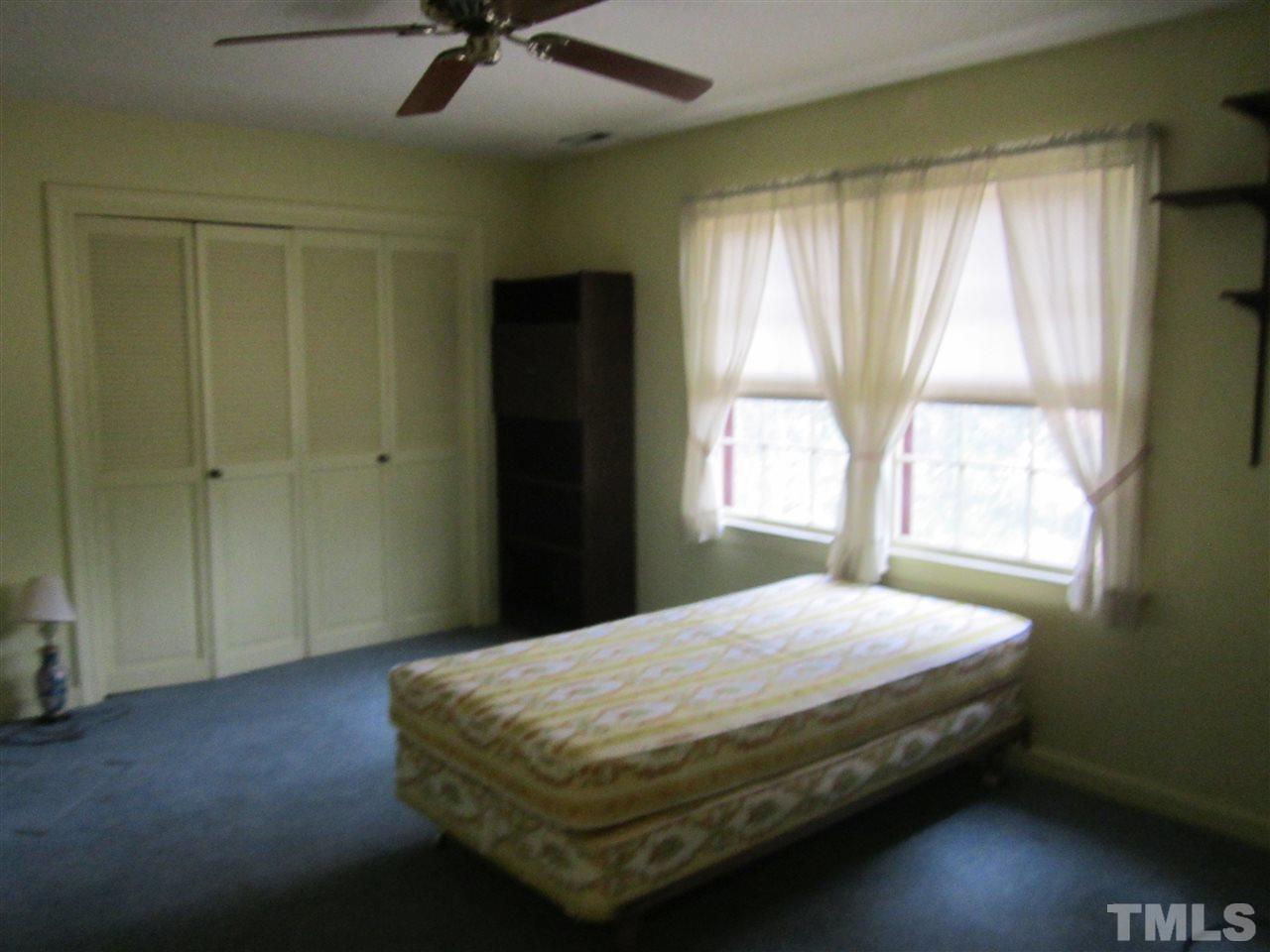 1401 Falls Church Road Raleigh, NC 27609 - Photo 5 of 11 a bedroom with a bed and window