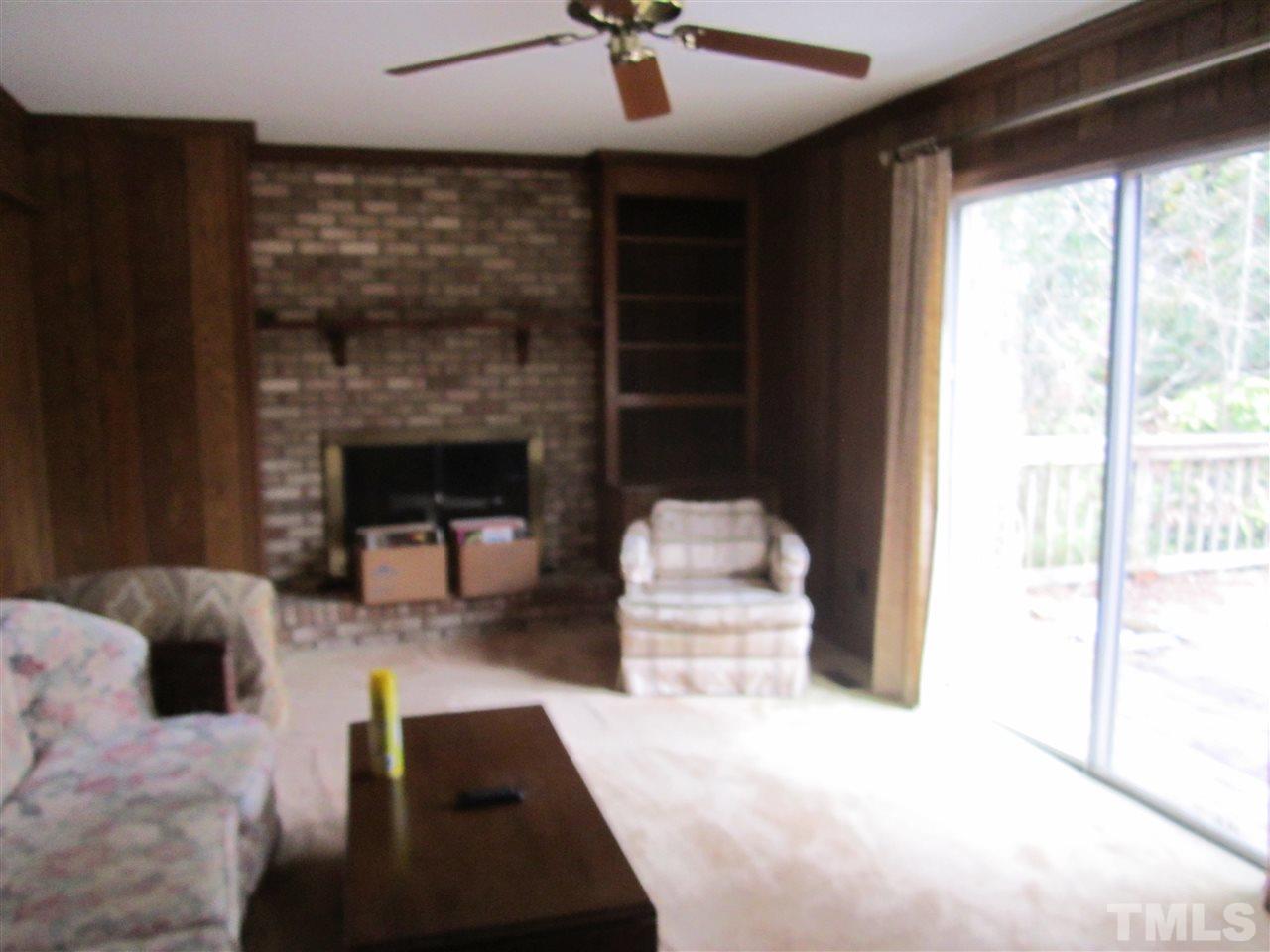 1401 Falls Church Road Raleigh, NC 27609 - Photo 7 of 11 a living room with furniture and a fireplace