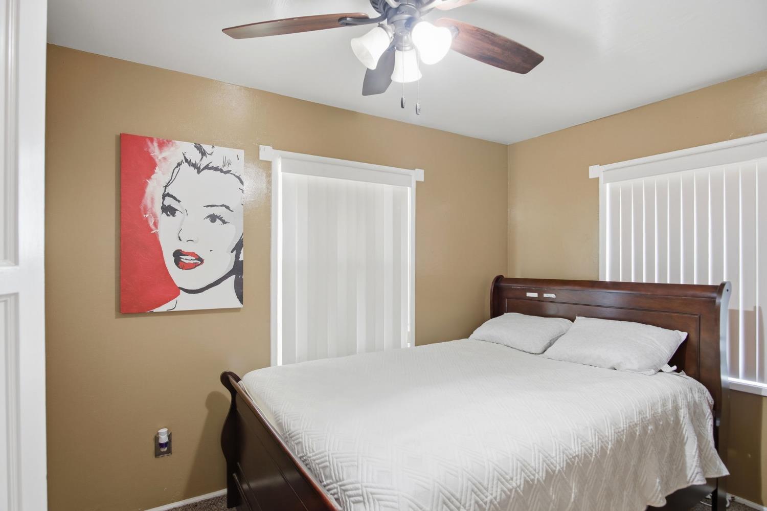 2406 South Walnut Road Turlock, CA 95380 - Photo 16 of 42 a bedroom with a bed and a chandelier