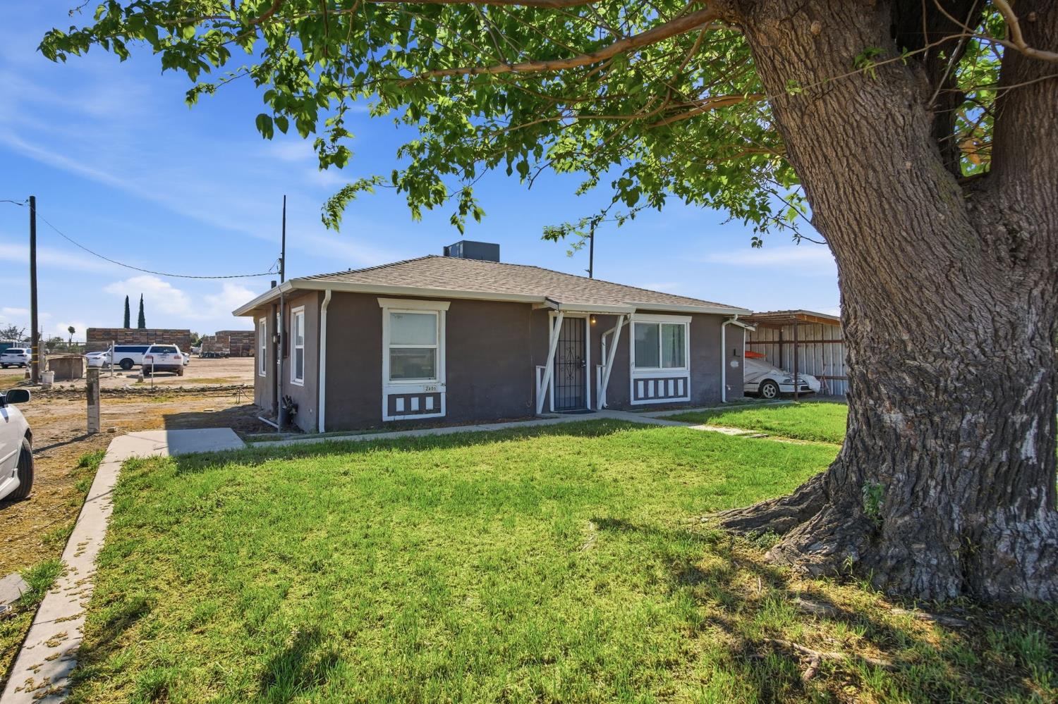 2406 South Walnut Road Turlock, CA 95380 - Photo 18 of 42 a view of a house with a yard