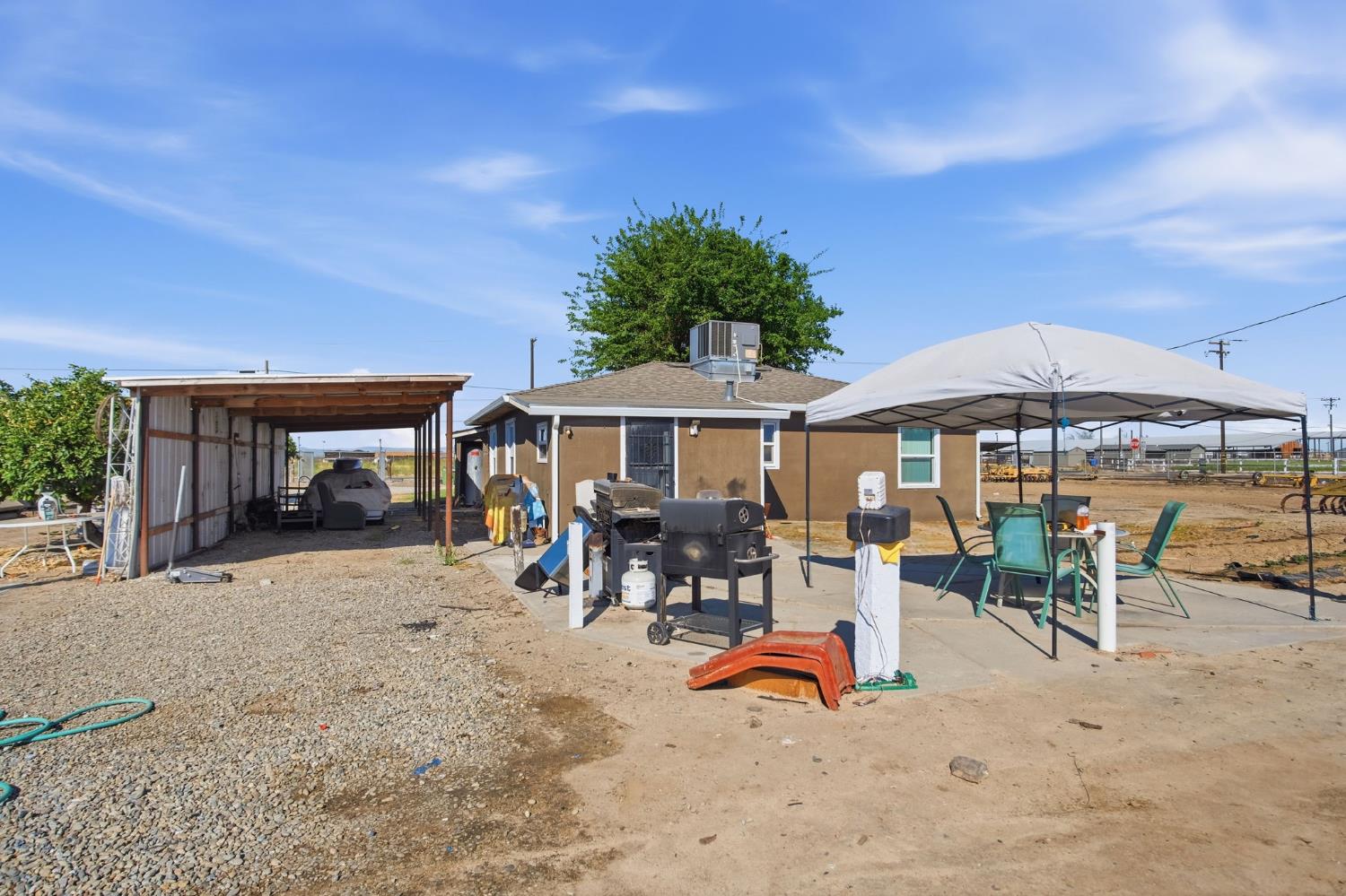 2406 South Walnut Road Turlock, CA 95380 - Photo 20 of 42 swimming pool with table and chairs under an umbrella