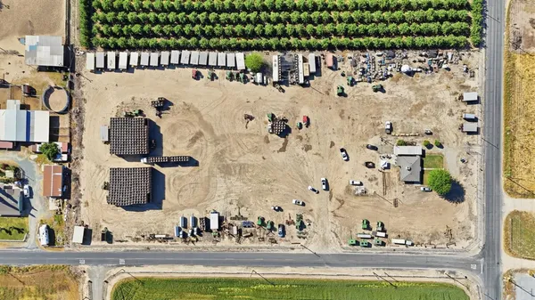 an aerial view of a residential houses with outdoor space