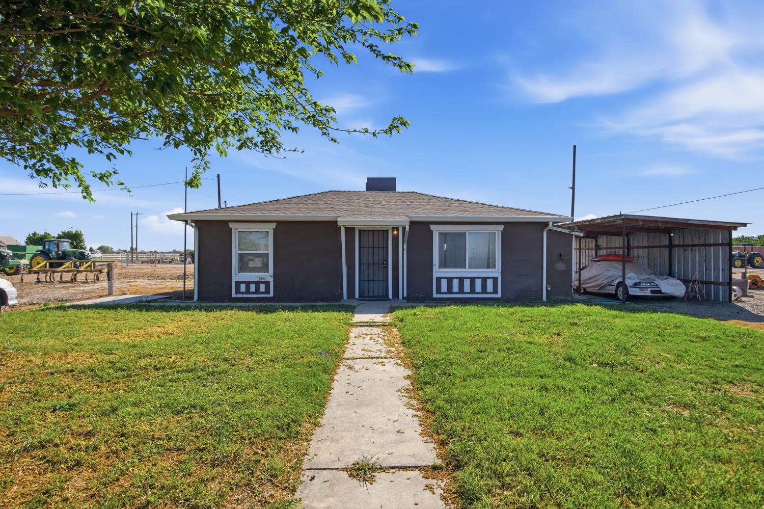 2406 South Walnut Road Turlock, CA 95380 - Photo 5 of 42 a front view of a house with a garden