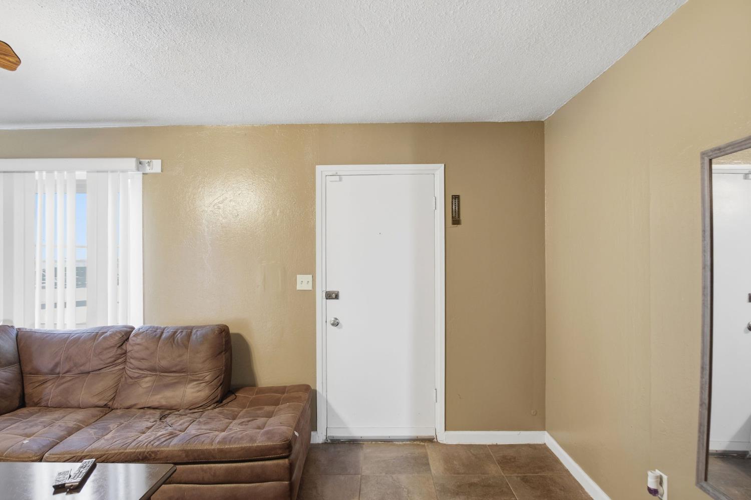 2406 South Walnut Road Turlock, CA 95380 - Photo 7 of 42 a living room with a couch and a window
