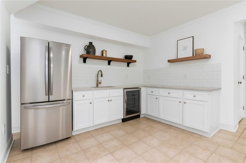 107 Smith Forest Lane Alpharetta, GA 30004 - Photo 15 of 29 a kitchen with white cabinets and white appliances