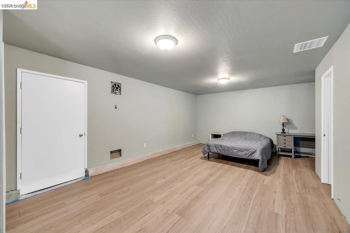 8733 Fraguero Road Sonora, CA 95370 - Photo 53 of 73 Spacious room featuring wood-finish flooring, light-toned wall paint, and ceiling-mounted lighting fixtures