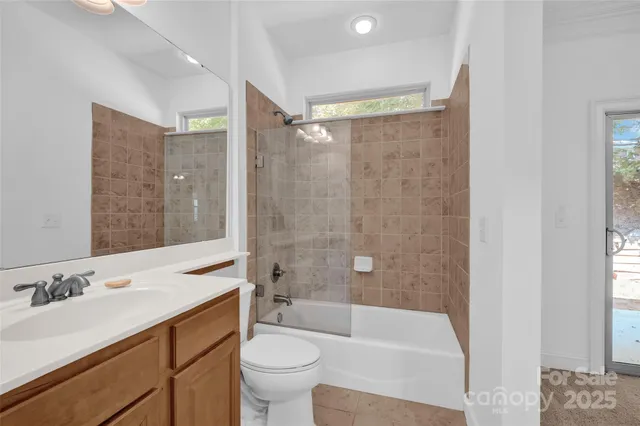 a bathroom with a sink mirror toilet and bathtub
