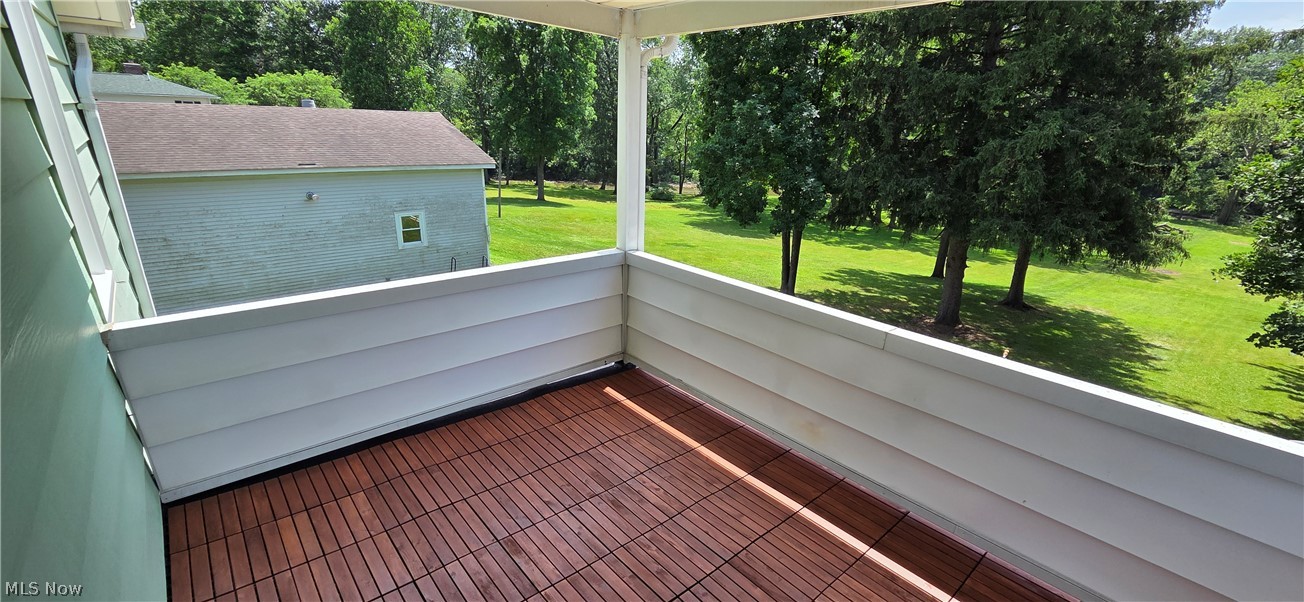 9964 East River Road Elyria, OH 44035 - Photo 31 of 45 Outdoor balcony featuring wood-finish flooring, white siding, and a partial roof overhead