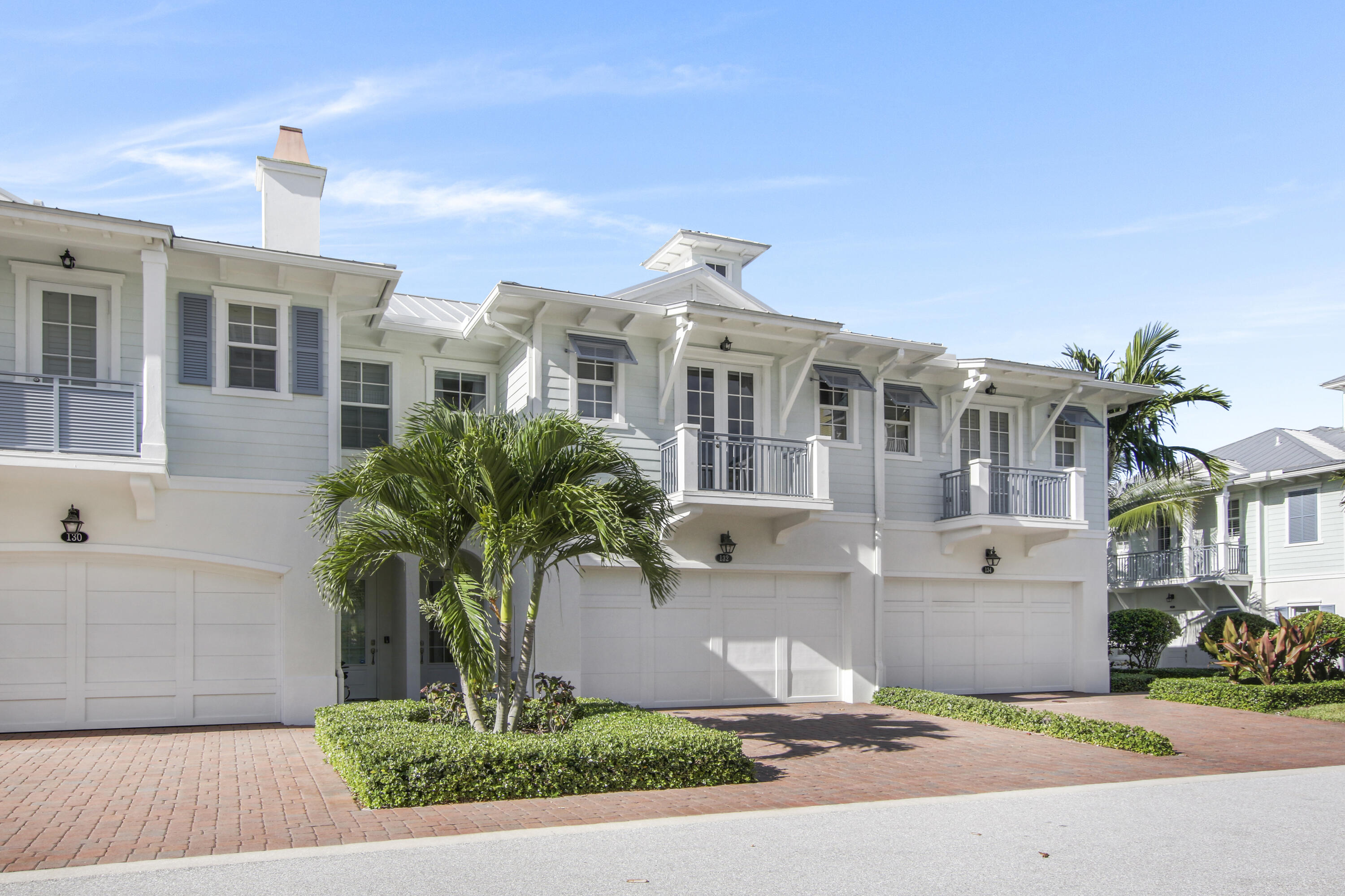 a front view of a house with yard and tree s