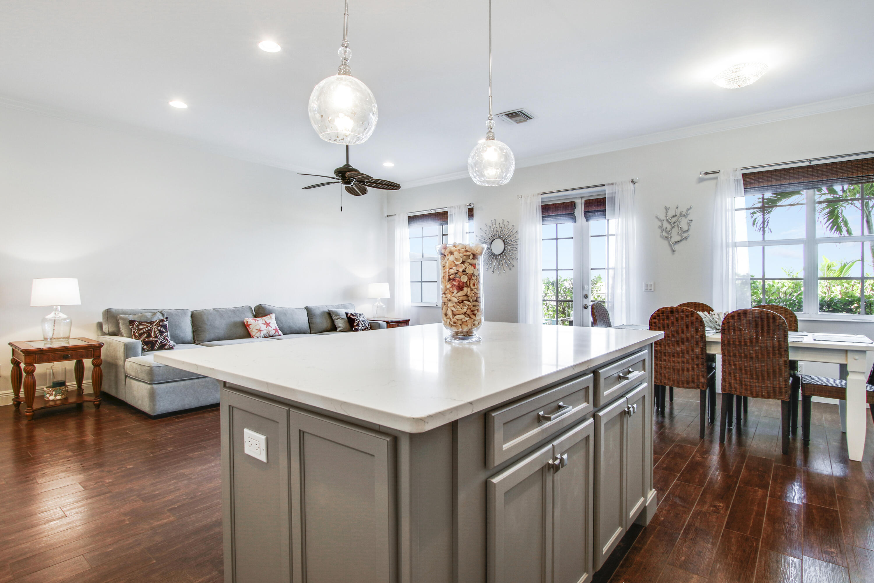 132 Ocean Breeze Drive Juno Beach, FL 33408 - Photo 13 of 33 a kitchen with a table chairs and a chandelier