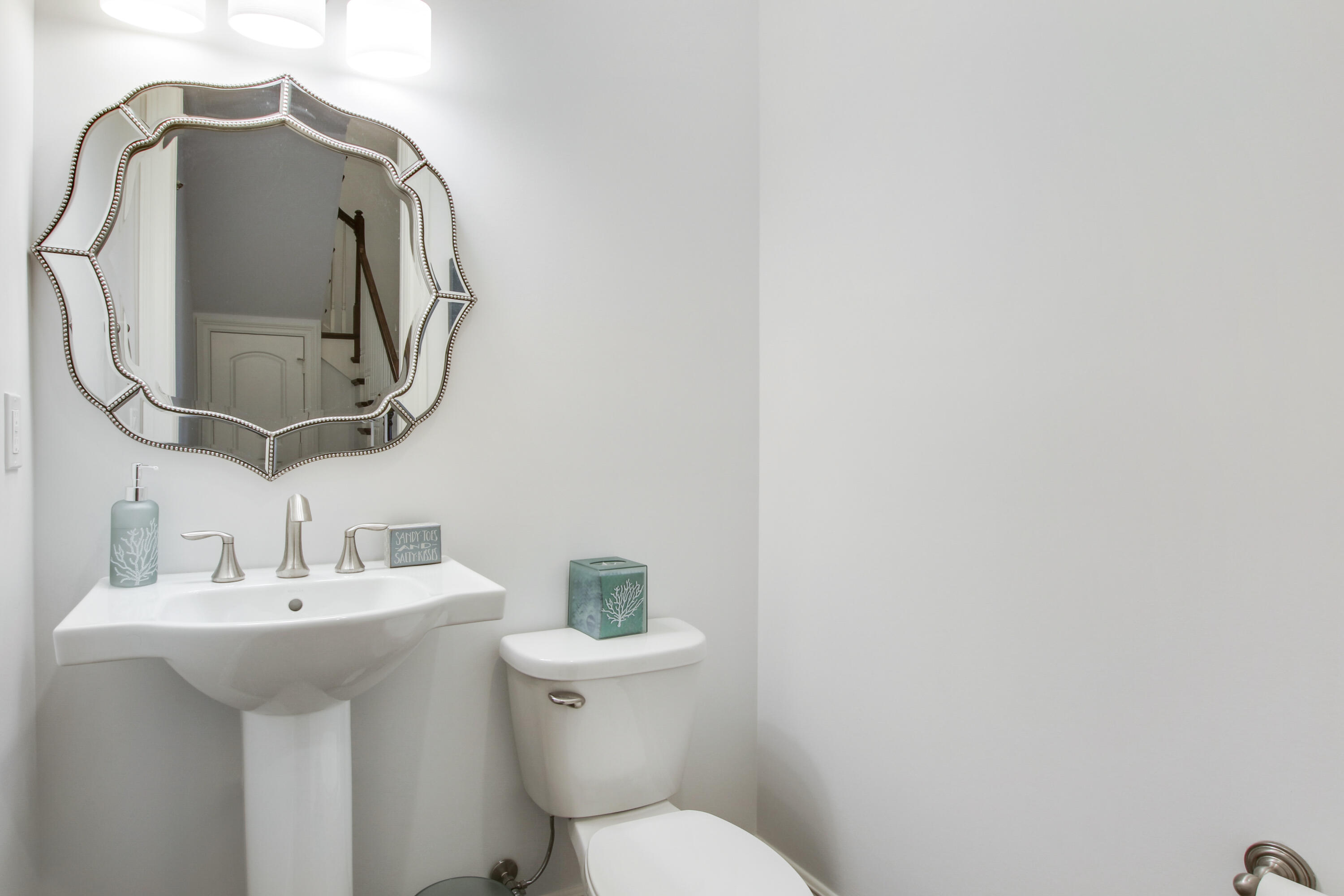 132 Ocean Breeze Drive Juno Beach, FL 33408 - Photo 16 of 33 a bathroom with a toilet sink and mirror