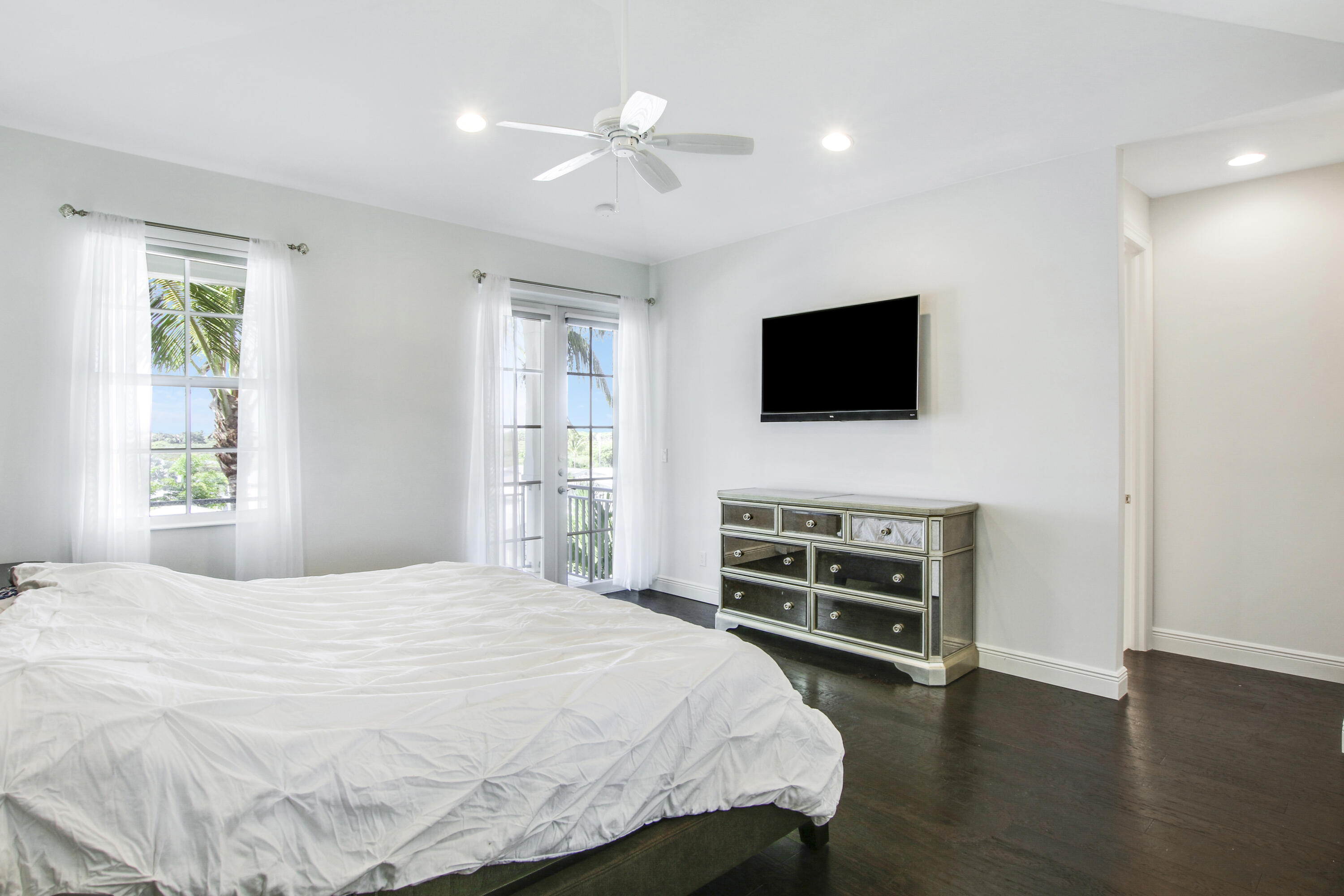 132 Ocean Breeze Drive Juno Beach, FL 33408 - Photo 22 of 33 a bedroom with a bed and a flat screen tv