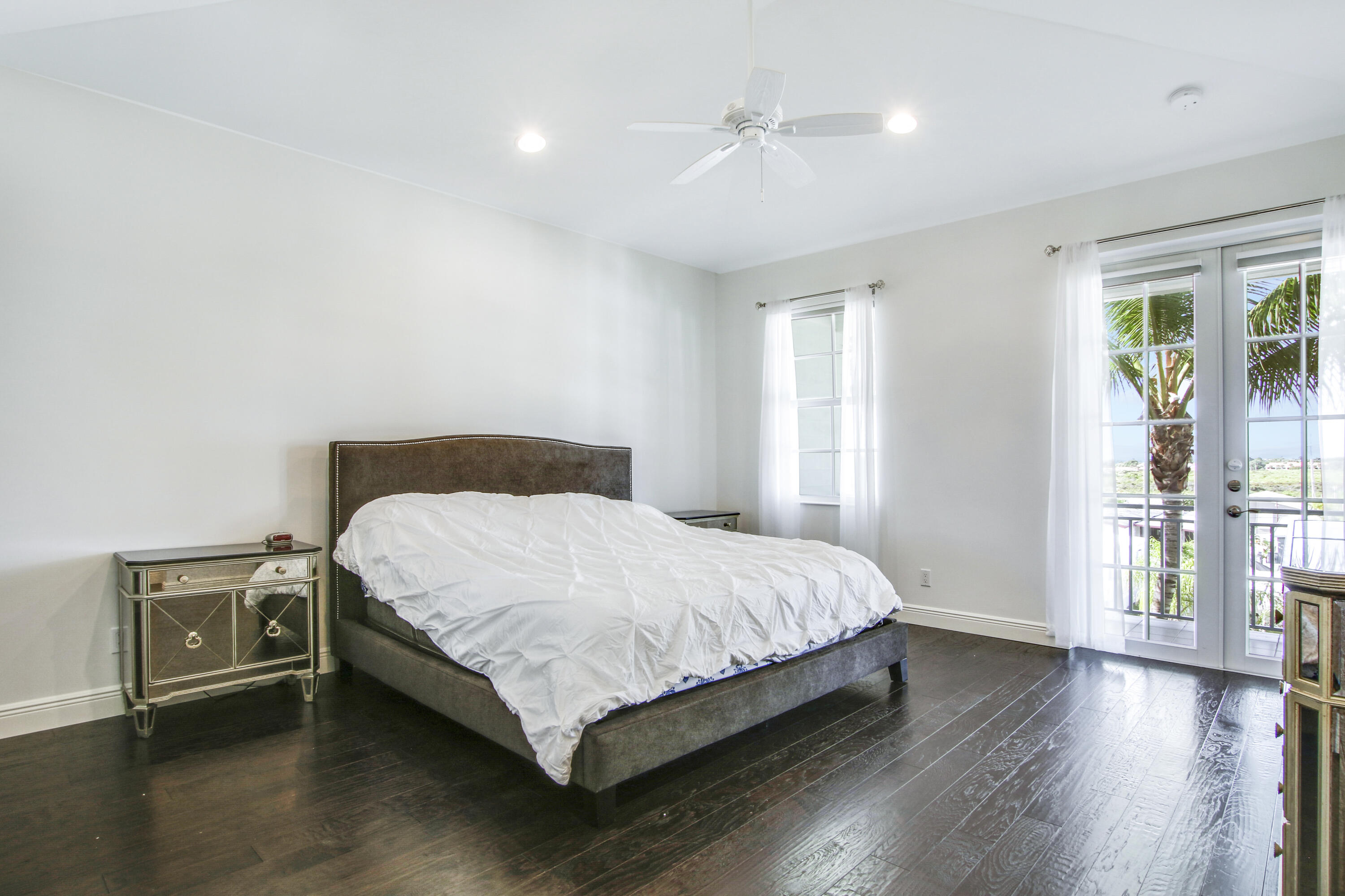 132 Ocean Breeze Drive Juno Beach, FL 33408 - Photo 23 of 33 a bedroom with a bed and wooden floor