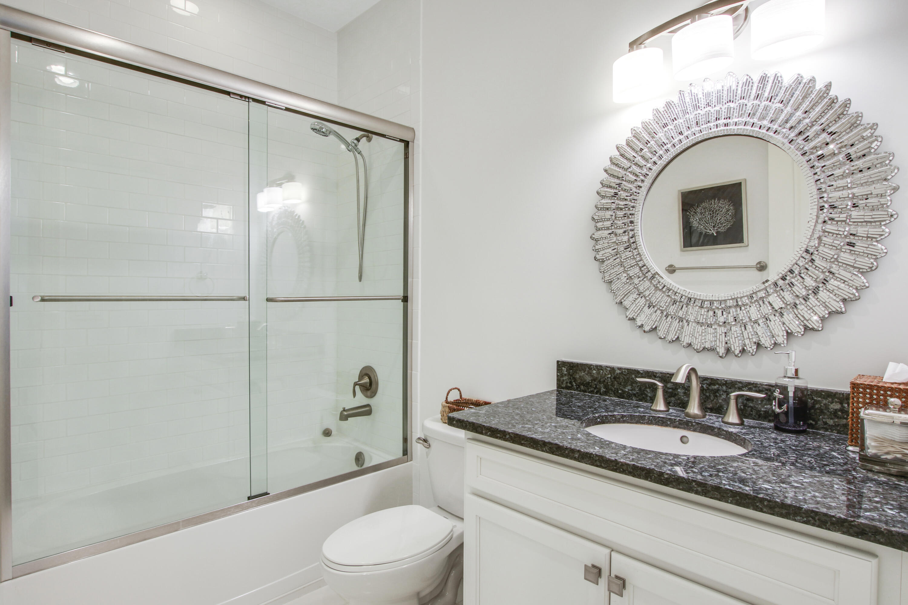 132 Ocean Breeze Drive Juno Beach, FL 33408 - Photo 29 of 33 a bathroom with a granite countertop sink a mirror and a shower