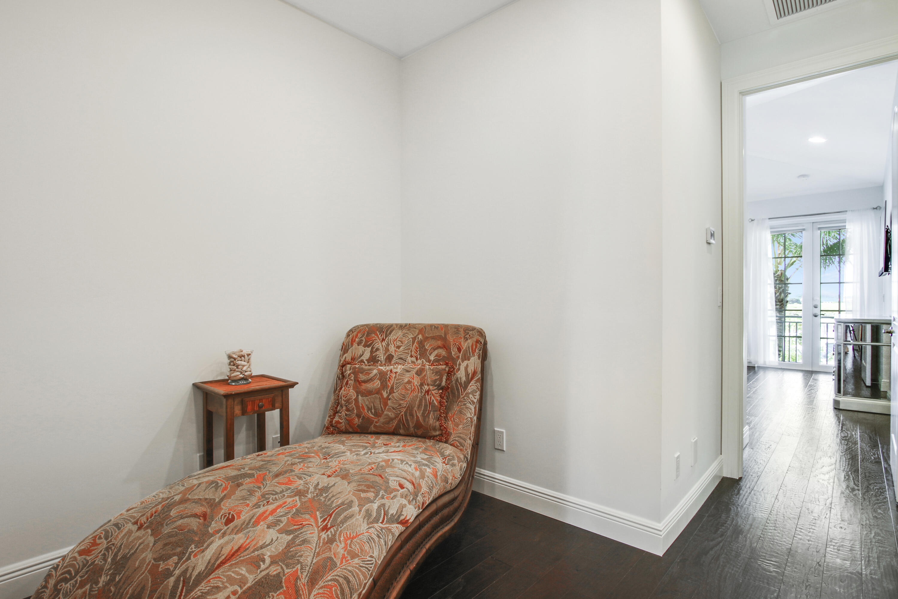 132 Ocean Breeze Drive Juno Beach, FL 33408 - Photo 30 of 33 a bedroom with a bed and a chair