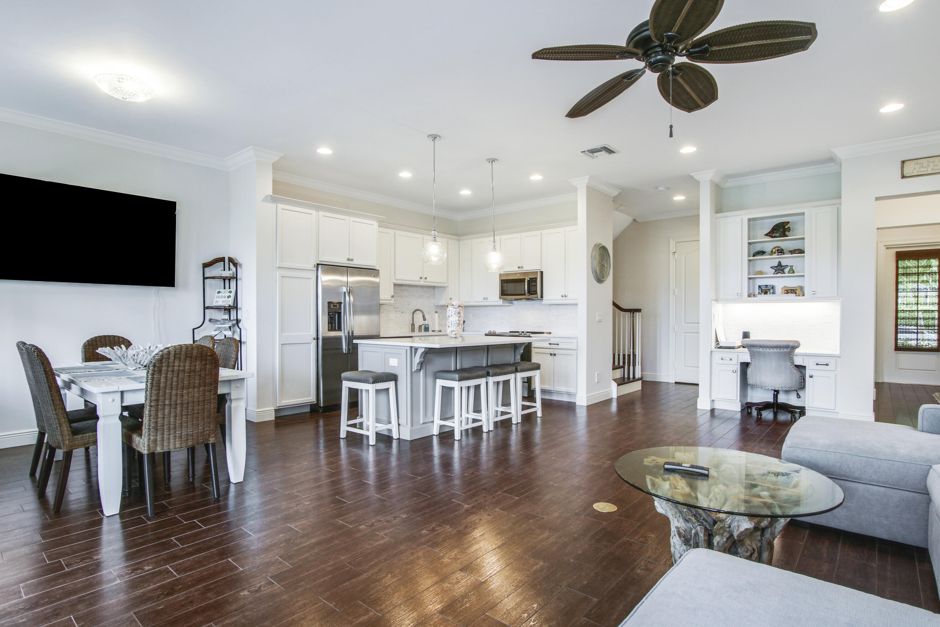 132 Ocean Breeze Drive Juno Beach, FL 33408 - Photo 4 of 33 a living room with furniture kitchen view and a flat screen tv