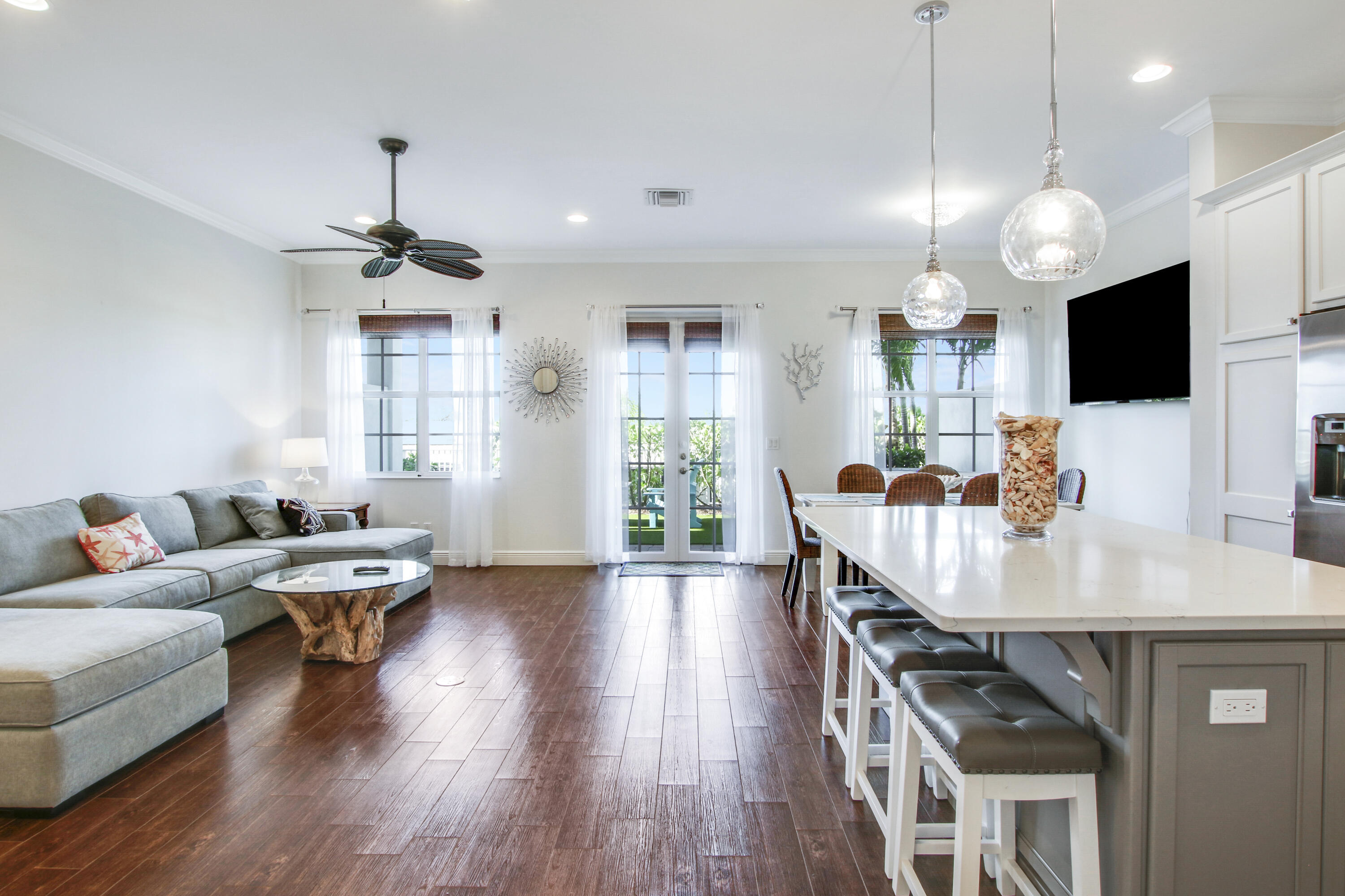 132 Ocean Breeze Drive Juno Beach, FL 33408 - Photo 8 of 33 a living room with furniture kitchen view and a wooden floor