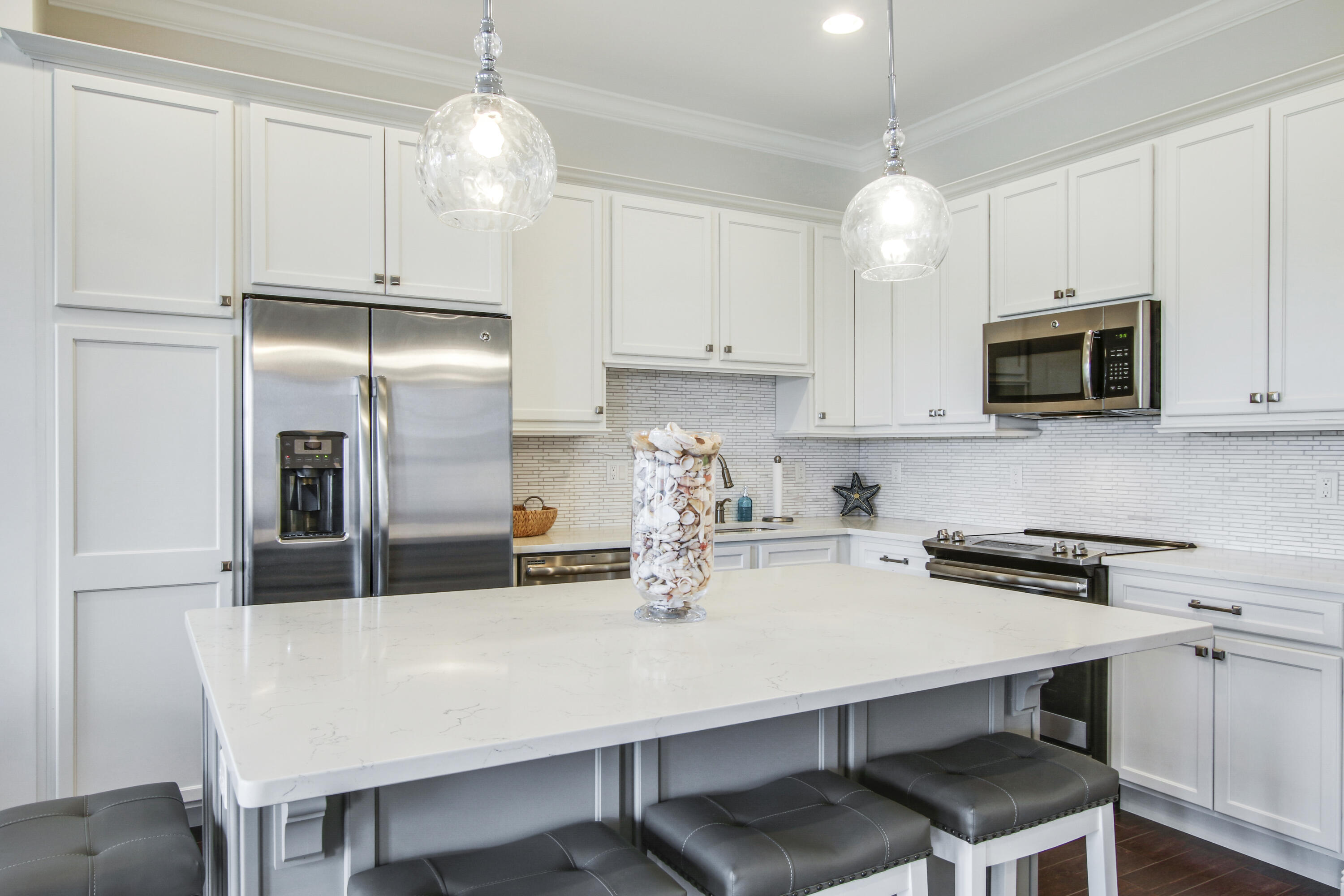 132 Ocean Breeze Drive Juno Beach, FL 33408 - Photo 10 of 33 a kitchen with kitchen island a cabinets counter space and stainless steel appliances