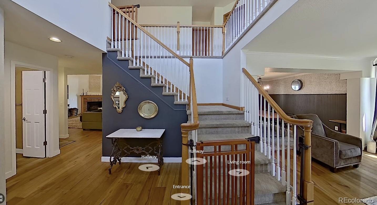 6887 Chestnut Hill Street Highlands Ranch, CO 80130 - Photo 2 of 7 a view of entryway livingroom and hall with wooden floor