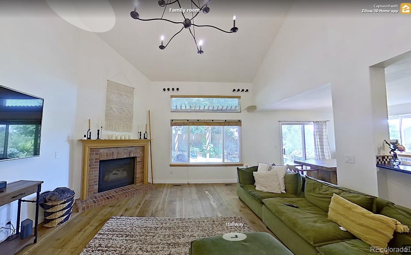 6887 Chestnut Hill Street Highlands Ranch, CO 80130 - Photo 3 of 7 a living room with furniture and a fireplace