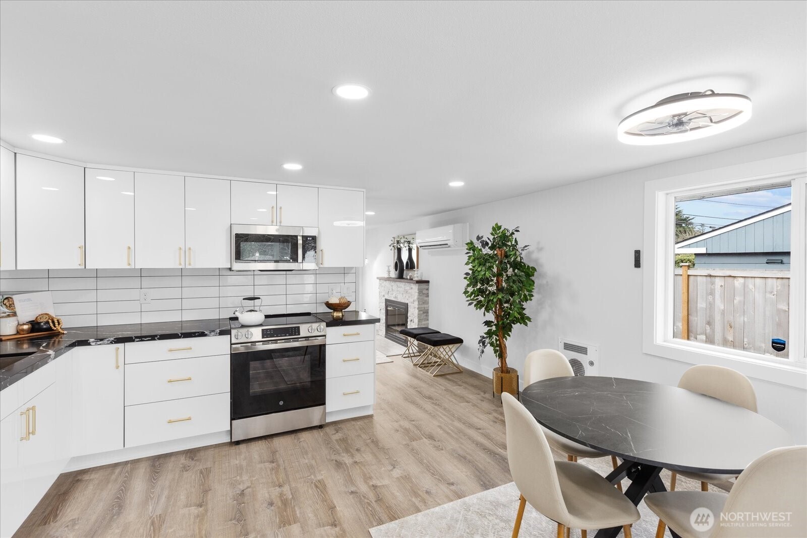 701 Pecks Drive Everett, WA 98203 - Photo 12 of 36 a kitchen with stainless steel appliances a stove a sink a microwave a refrigerator and cabinets