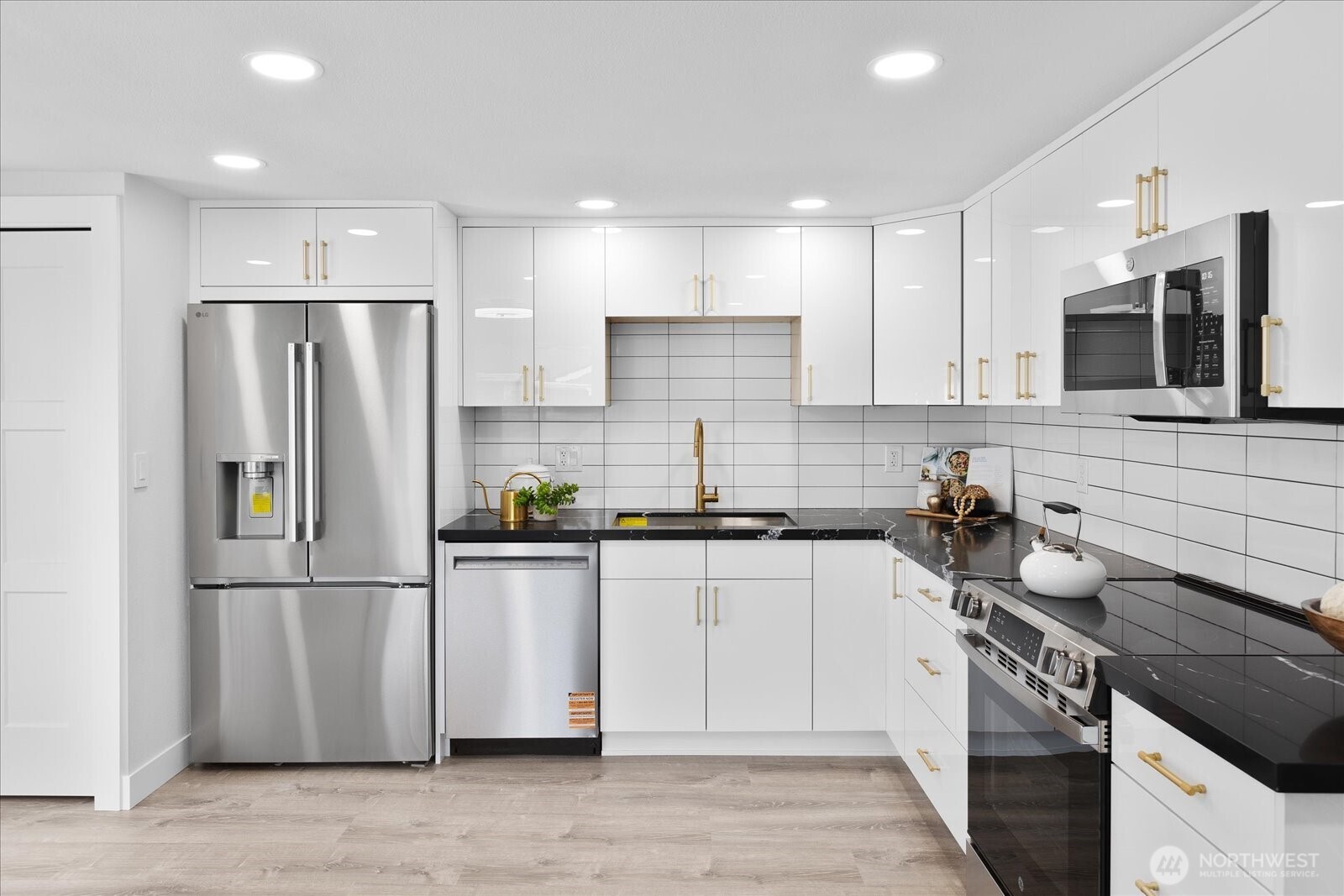701 Pecks Drive Everett, WA 98203 - Photo 14 of 36 a kitchen with stainless steel appliances a refrigerator stove top oven and sink