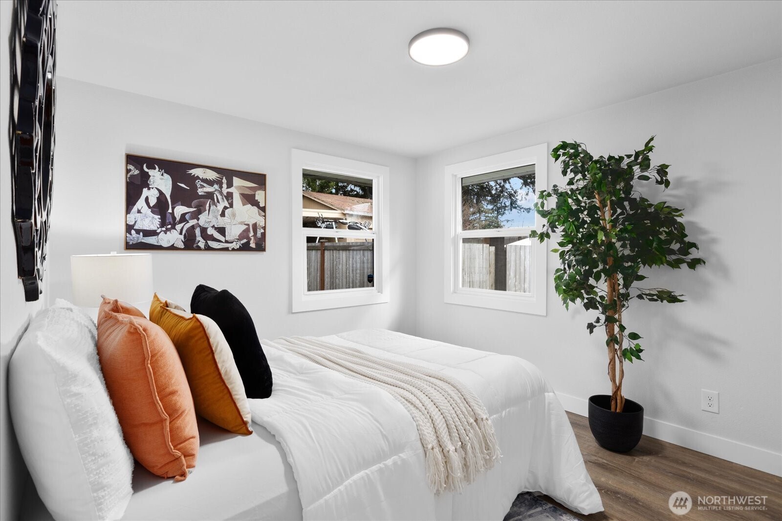 701 Pecks Drive Everett, WA 98203 - Photo 21 of 36 a bedroom with a bed and a potted plant