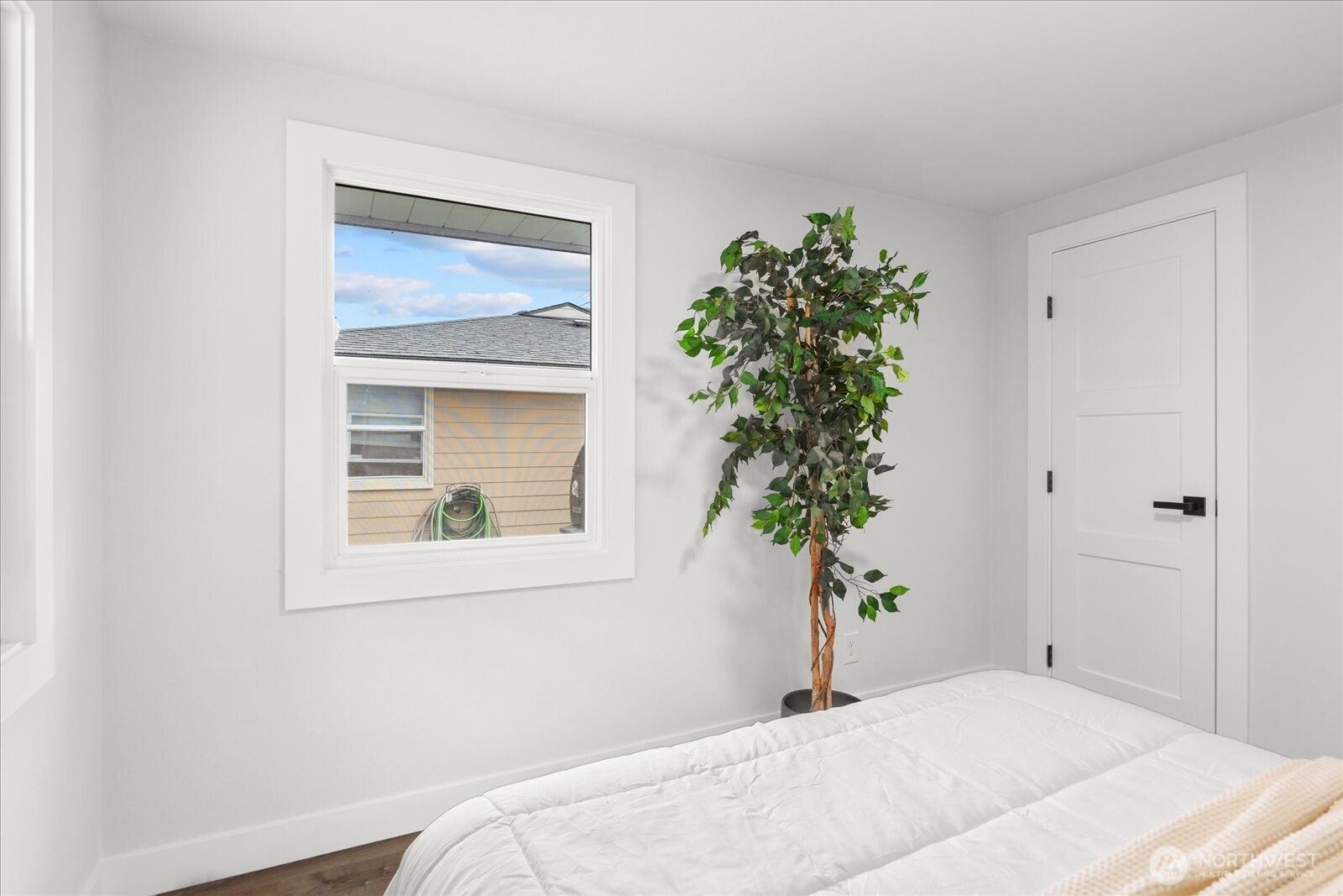 701 Pecks Drive Everett, WA 98203 - Photo 23 of 36 a bedroom with a bed and a potted plant