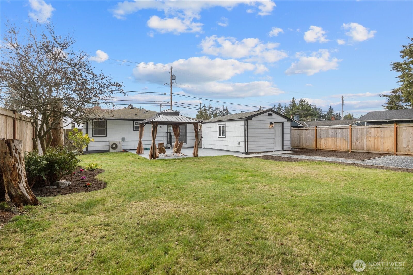 701 Pecks Drive Everett, WA 98203 - Photo 24 of 36 a view of a house with a backyard and a patio