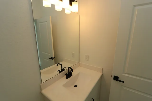 a view of hallway with window and refrigerator