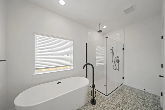 a bathroom with a bathtub and a shower