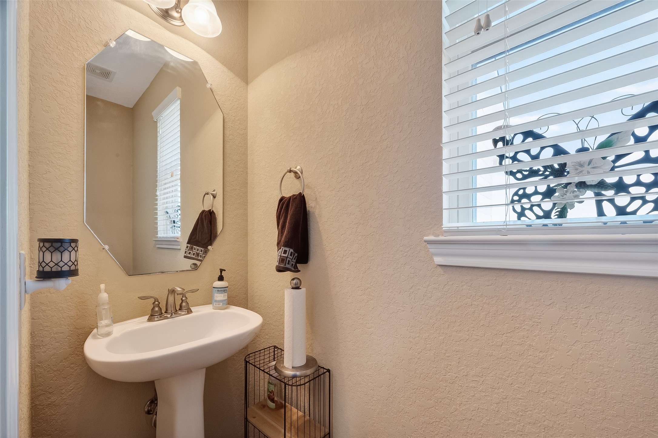3418 Barbers Hill Road Highlands, TX 77562 - Photo 28 of 50 a bathroom with a sink and a mirror